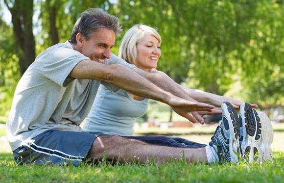 Picture of married couple stretching before exercising
